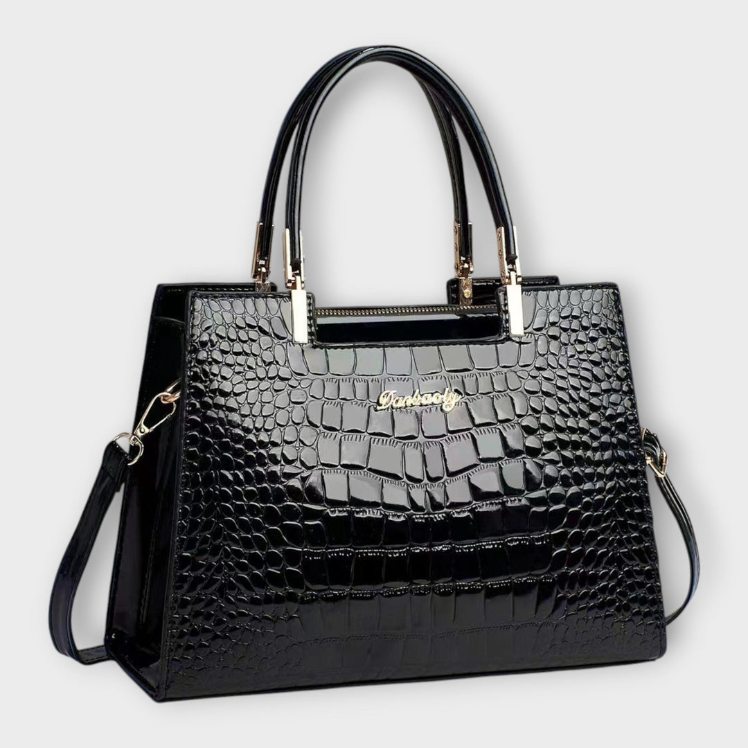 Women's classic structured top handle handbag in black, front view, perfect for sophisticated style.