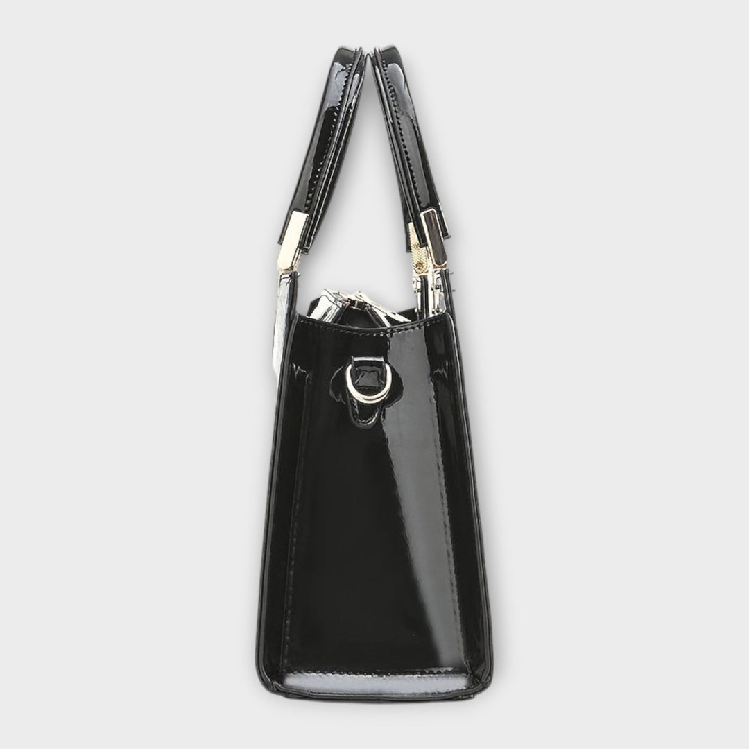 Sophisticated black top handle purse for women, close-up of textured material and classic design.