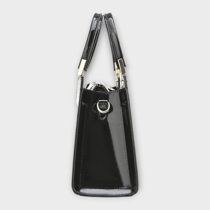 Sophisticated black top handle purse for women, close-up of textured material and classic design.