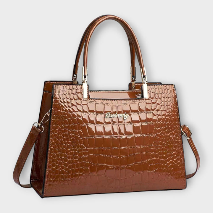 Classic black top handle handbag for women with a structured silhouette, suitable for formal occasions.