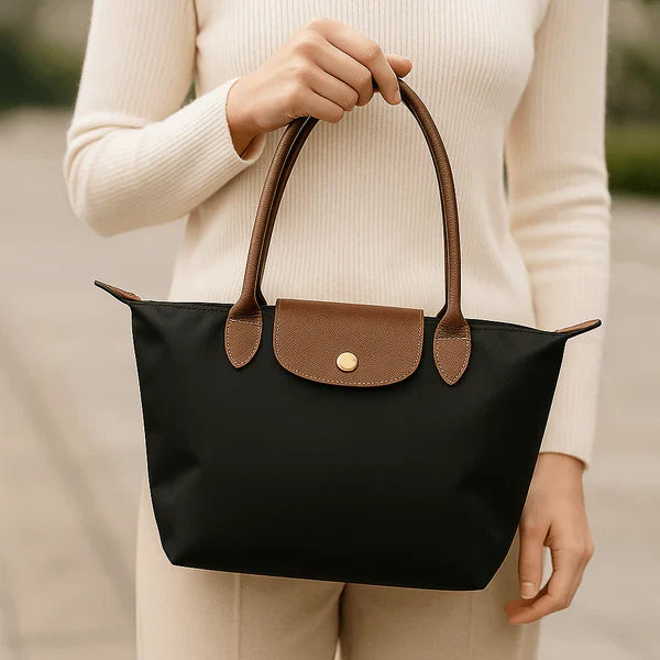 Elegant women's structured two-tone faux leather tote bag with sturdy handles, ideal as a classic shoulder bag.