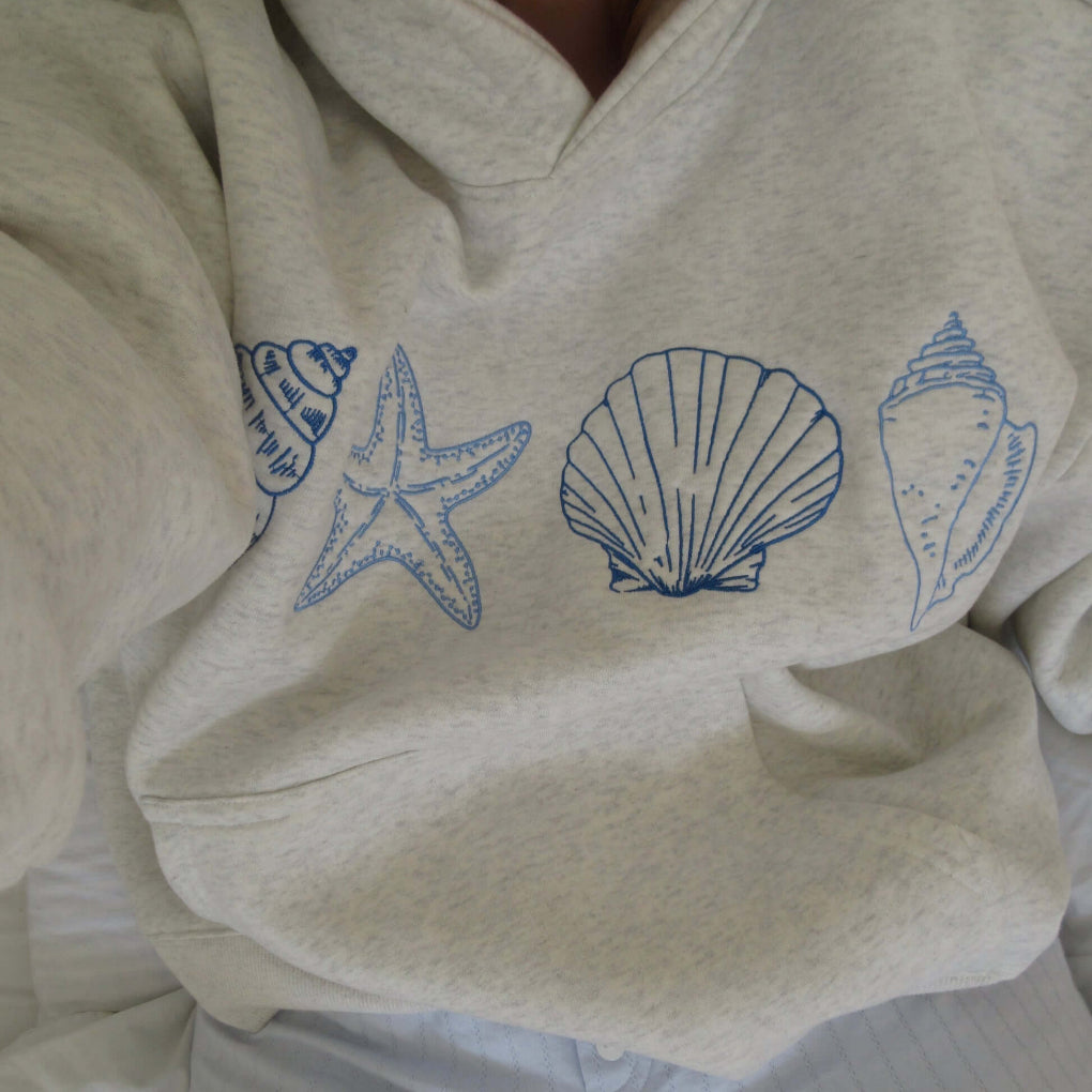 Women's coastal seashell print hoodie, soft fabric, relaxed fit, pouch pocket, perfect for beach style casual wear