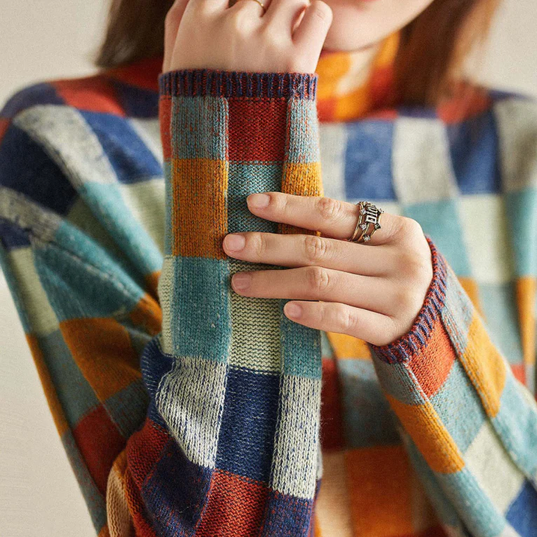 Model wearing a comfortable women's color block check knitted sweater, perfect for casual winter wear.