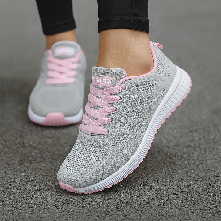 Close-up of women's athletic walking shoe featuring arch support & sporty style design.