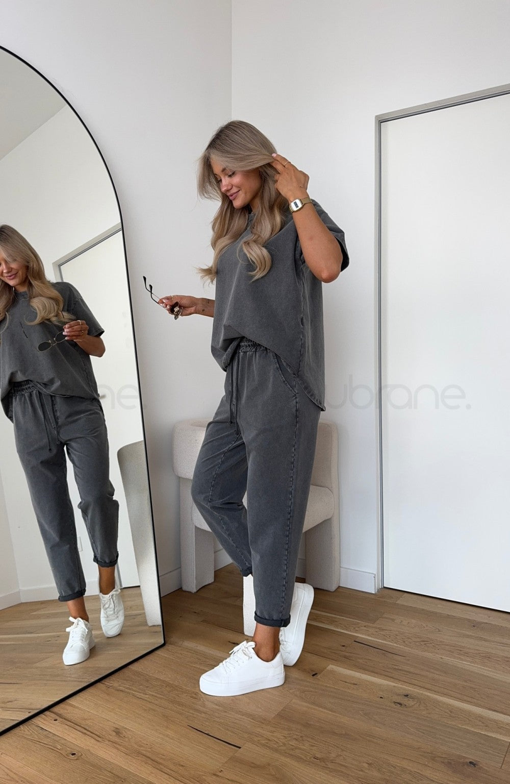Close-up of women's two-piece lounge set fabric, showcasing ripped detail and soft comfort wear texture