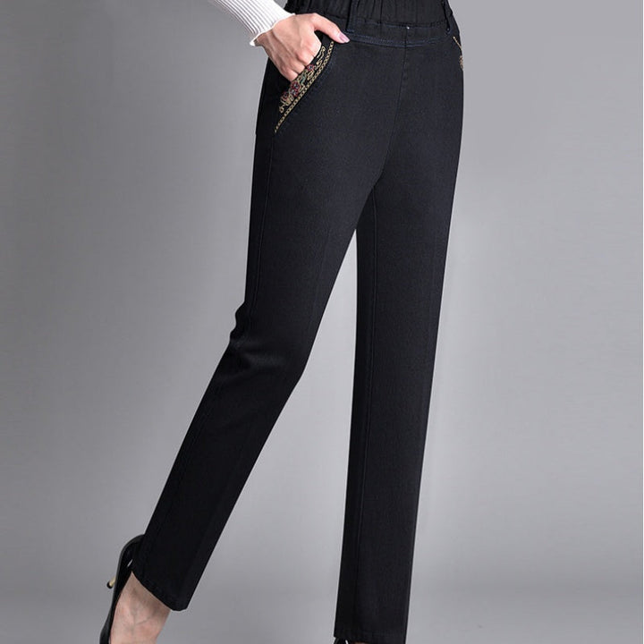 Detail of the durable denim fabric and stitching on women's comfort-fit jeans with pockets.