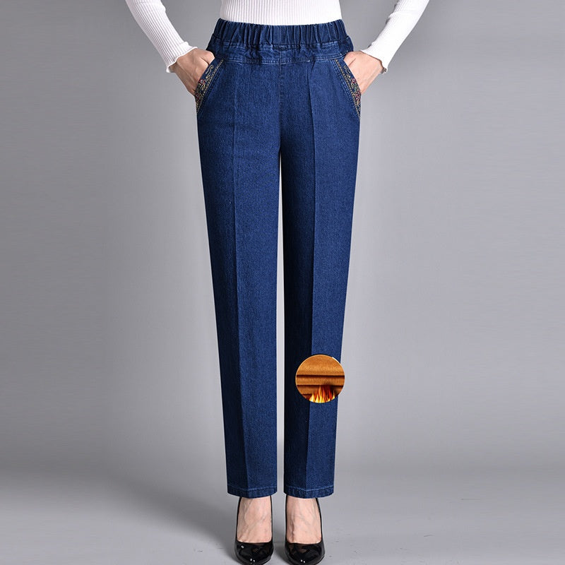 Stack of folded women's comfort-fit jeans with elastic waist, ready for casual fall and winter outfits.
