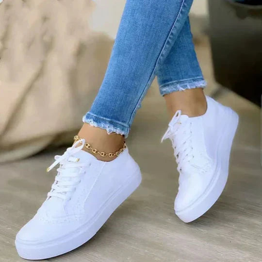 Three pairs of women's sneakers: black, brown, and white lace-up shoes for everyday comfort