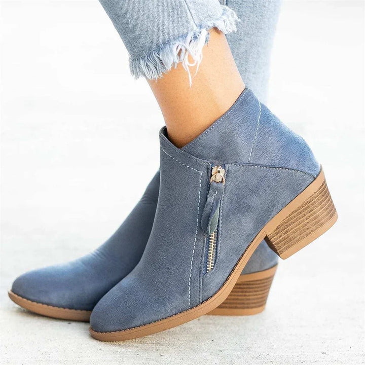 Fashionable women's leather ankle boots featuring a convenient side zipper, built for comfort and versatile wear.