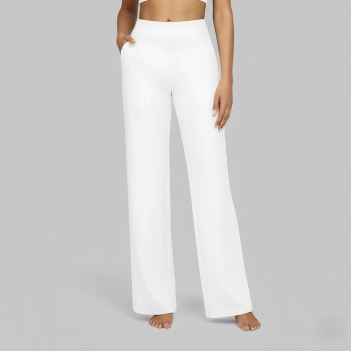 Stylish woman pairing comfortable black stretch pants with a casual top, everyday fashion.