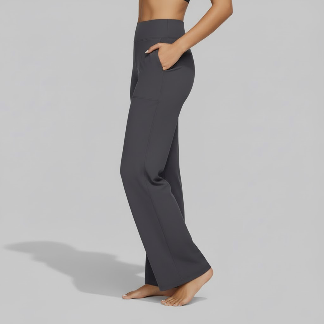 Model demonstrating the flexibility of women's comfortable gray stretch pants during movement.