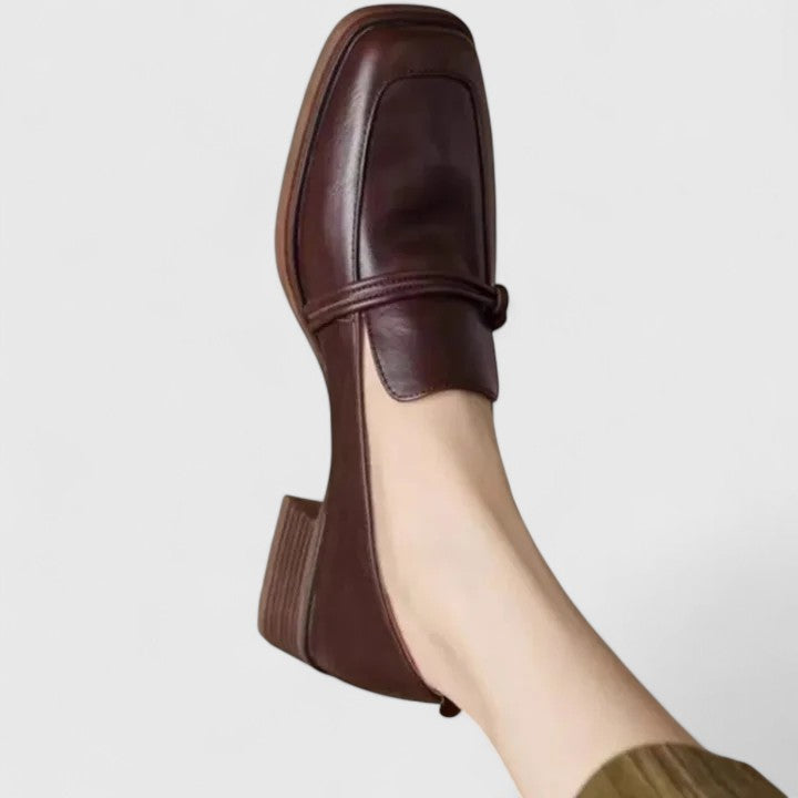 Close-up of women's comfortable classic slip-on loafers in black, highlighting the soft material and flat sole.