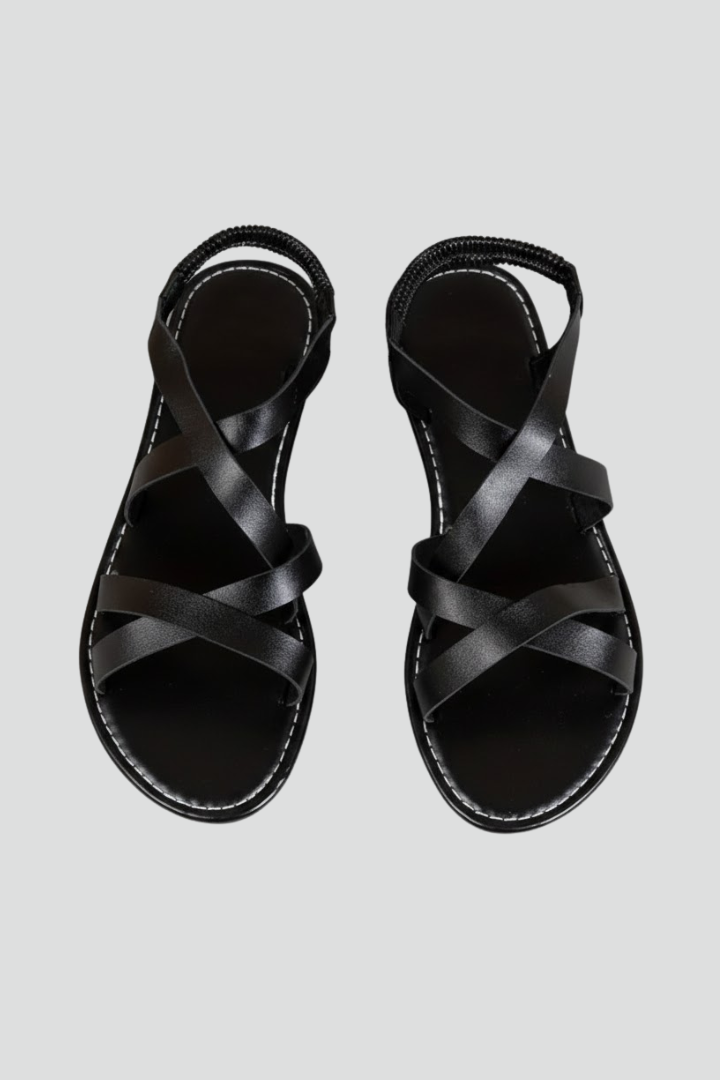 Women's comfortable flat sandals with criss-cross straps, ideal for summer casual wear and beach outings.