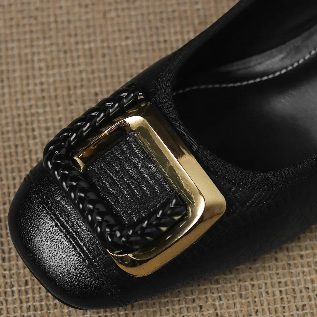 Close-up of women's black textured block heel pumps, highlighting the comfortable low heel and fashionable square toe
