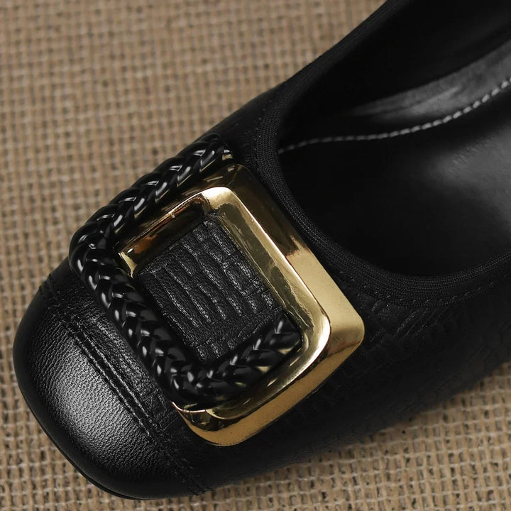 Close-up of women's black textured block heel pumps, highlighting the comfortable low heel and fashionable square toe