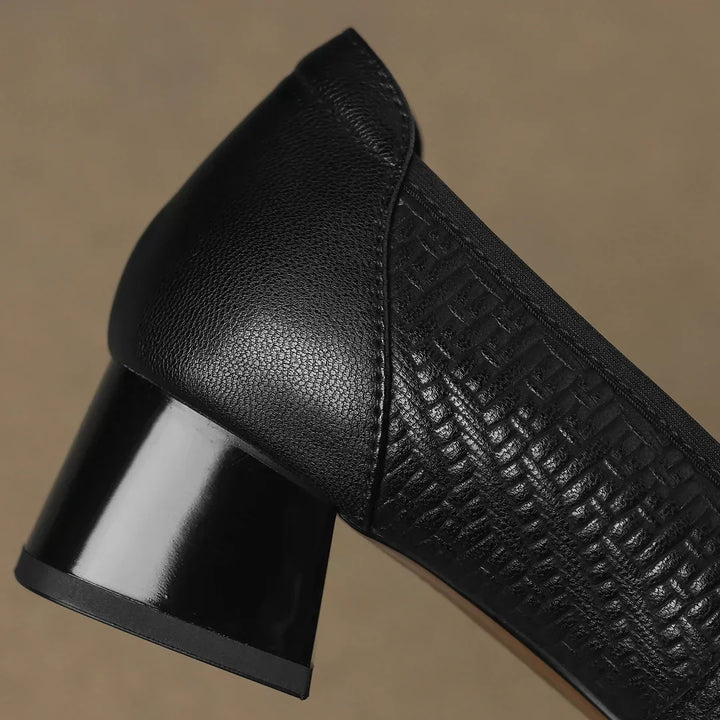 Elegant women's black low block heel pumps with a prominent gold buckle and a comfortable square toe design