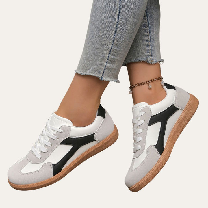 Close-up of comfortable women's low top sneakers, highlighting textured sole and breathable material.