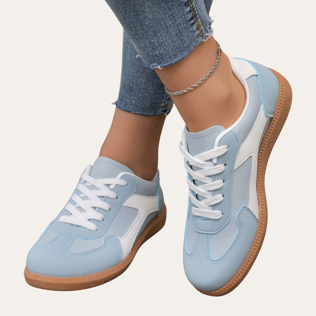 Pair of navy blue women's low top casual shoes, ideal for versatile everyday wear and comfort.
