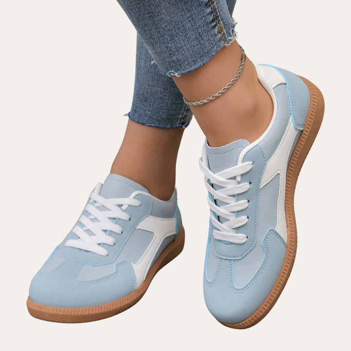 Pair of navy blue women's low top casual shoes, ideal for versatile everyday wear and comfort.