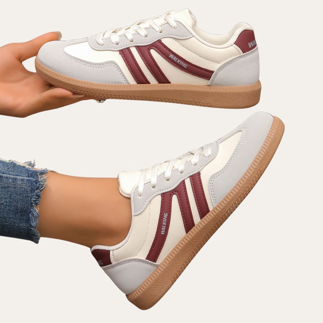 Woman walking in comfortable white low top casual sneakers, showcasing versatile spring footwear.