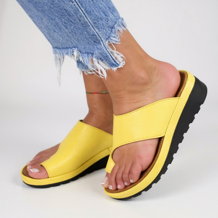 Close-up of the orthopedic support and toe split design on a pair of comfortable women's summer sandals.
