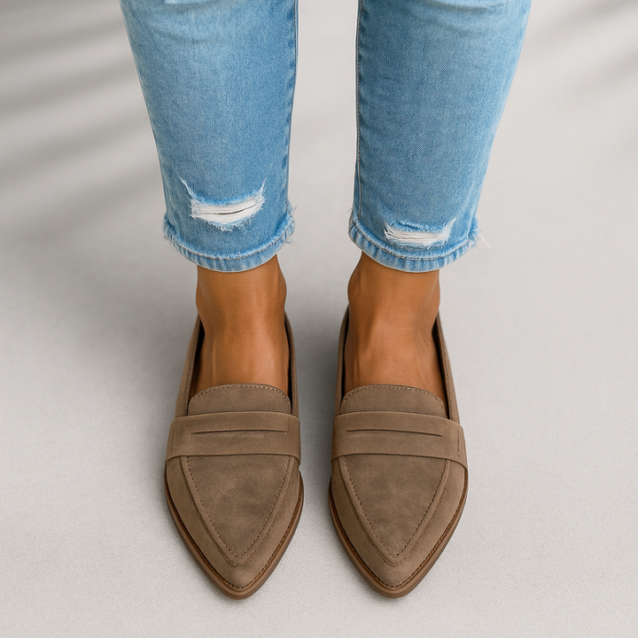 Women's fashion flats: comfortable slip-on loafers on a wooden background
