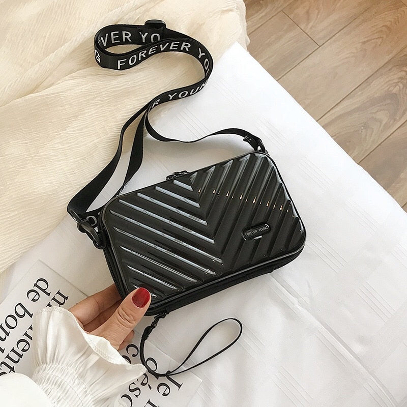 Chic hard shell crossbody travel bag for women; compact, waterproof, and durable for essentials.