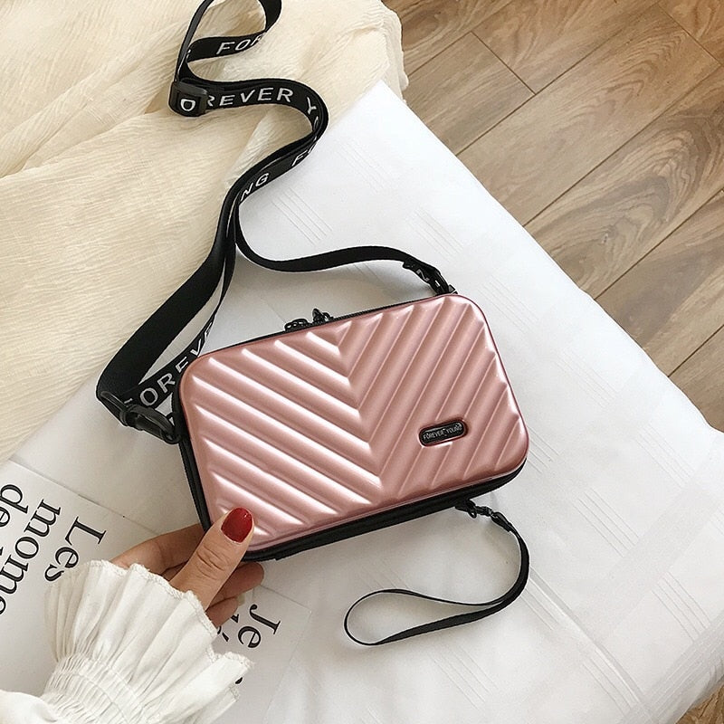 Fashionable women's mini purse; hard shell, waterproof, and compact shoulder bag for essentials.