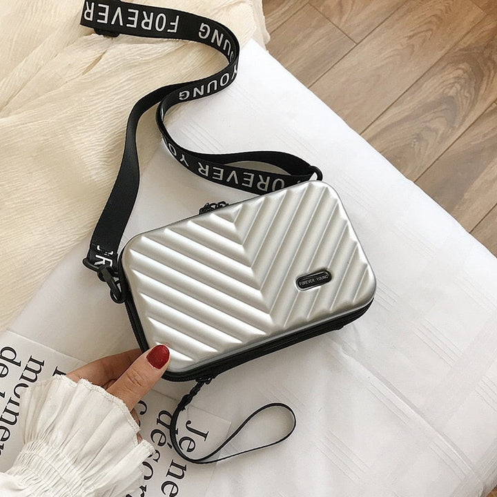 Durable hard shell compact handbag for women; waterproof travel bag, perfect for essentials.