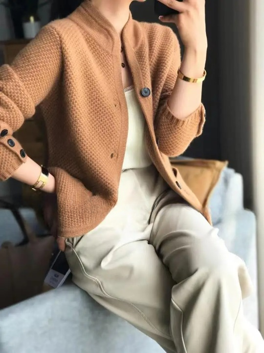 Women's button front winter cardigan paired with a simple top, emphasizing its casual elegance.
