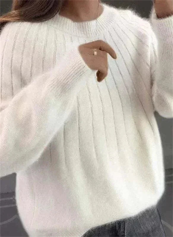 Close-up of the textured knit pattern on a women's winter sweater, showing quality and warmth.