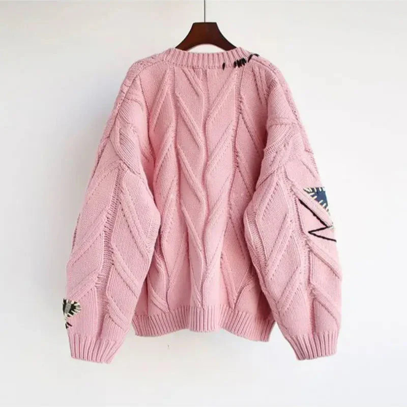Women's cozy knit V-neck cardigan with intricate patchwork embroidery, relaxed fit, perfect for autumn.