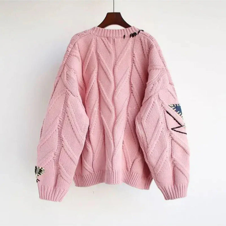Women's cozy knit V-neck cardigan with intricate patchwork embroidery, relaxed fit, perfect for autumn.