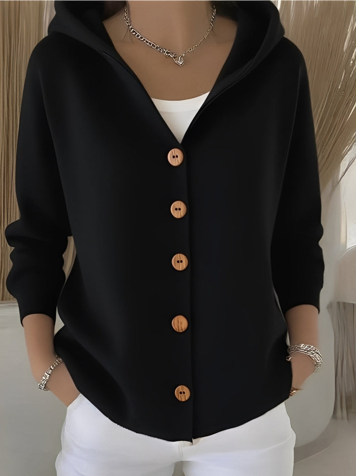 Warm knitted hooded cardigan for women, button-front, blending comfort with trendy casual style.