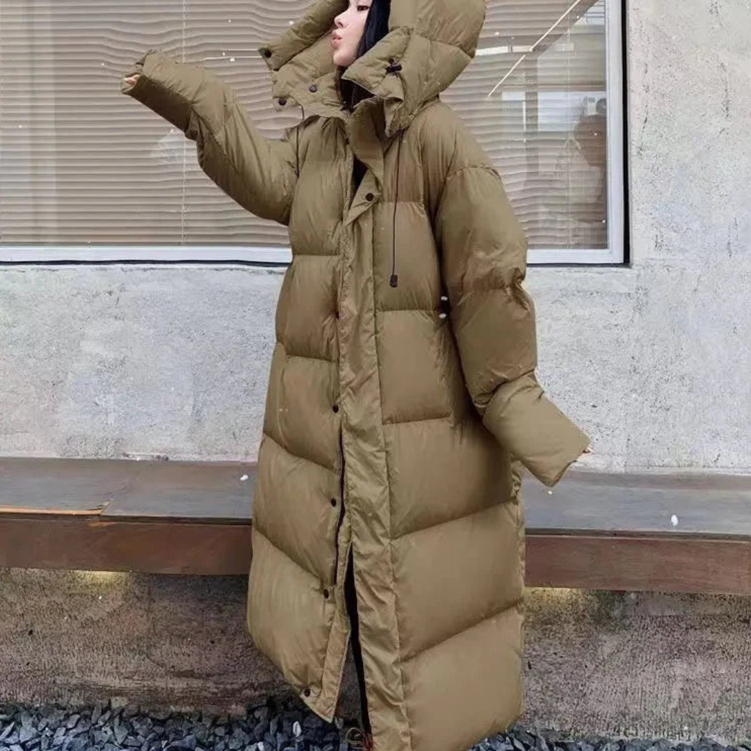 Women's cozy long puffer hooded jacket. Stylish winter outerwear, perfect for cold weather. Features an oversized fit.