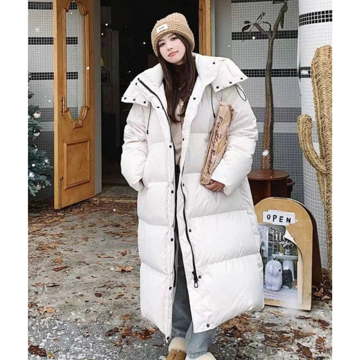 Women's black long puffer hooded jacket, keeping you warm & stylish. A cozy, oversized winter coat for cold weather.