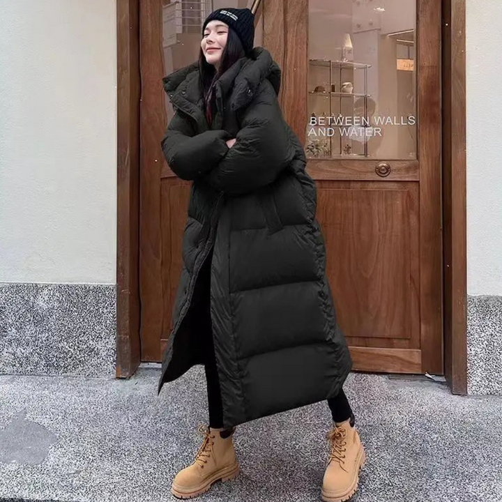 Stylish women's long hooded puffer jacket. A warm, cozy winter essential for cold weather, perfect for everyday wear.