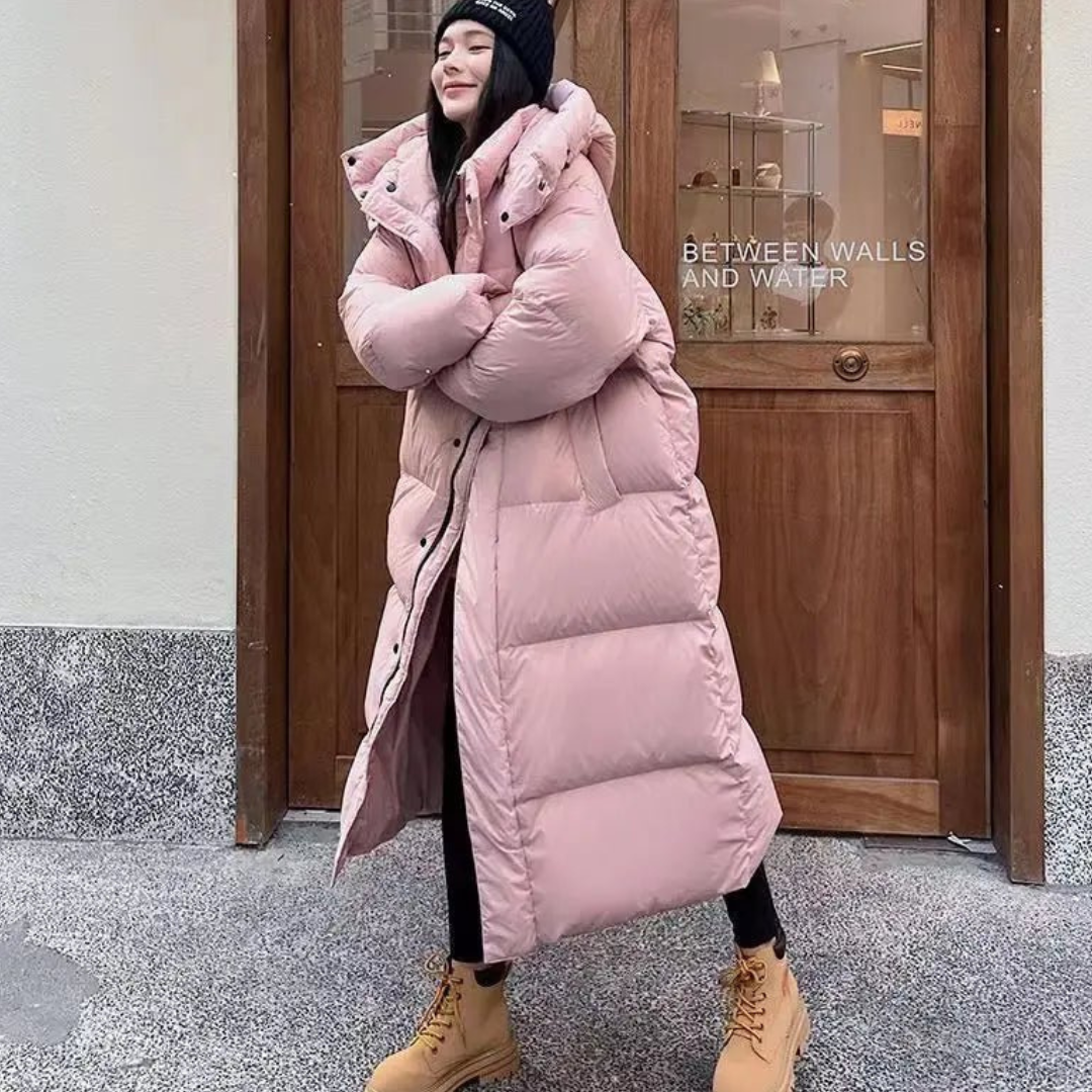 Winter essential: Women's warm long hooded puffer jacket. Cozy, oversized fit for ultimate comfort in cold weather fashion.