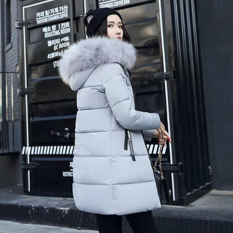 Warm women's long hooded winter parka, ideal for cold weather travel & outdoor protection. Insulated for comfort.
