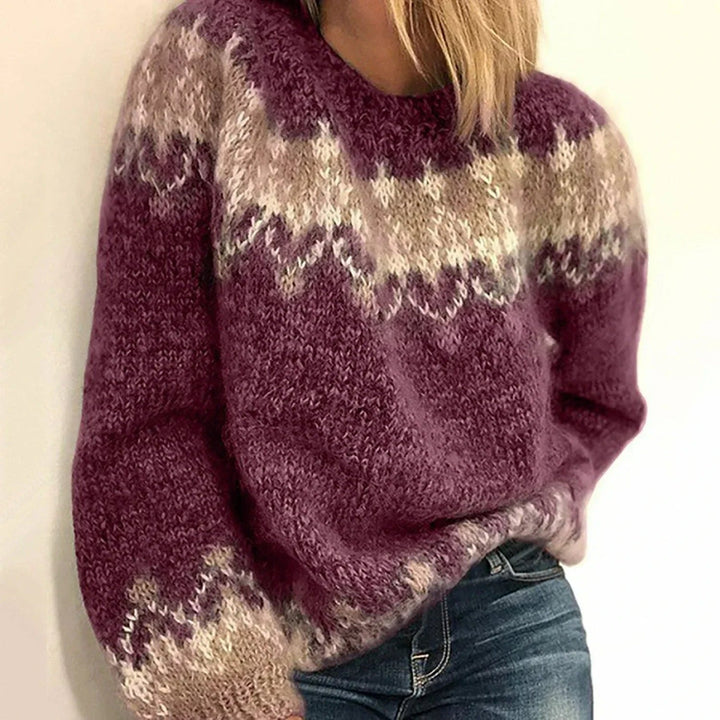 Close-up of a women's cozy knit winter sweater showing intricate pattern and soft texture.