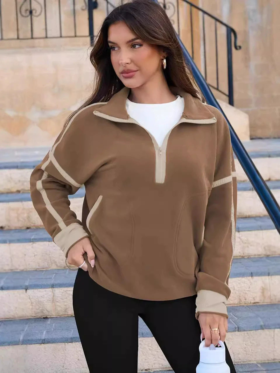 Women's half-zip pullover sweater with a cozy texture, designed for comfortable everyday wear.