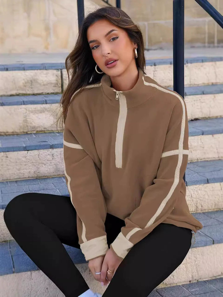 Woman wearing a comfortable quarter-zip pullover sweater, suitable for casual outings & warmth.