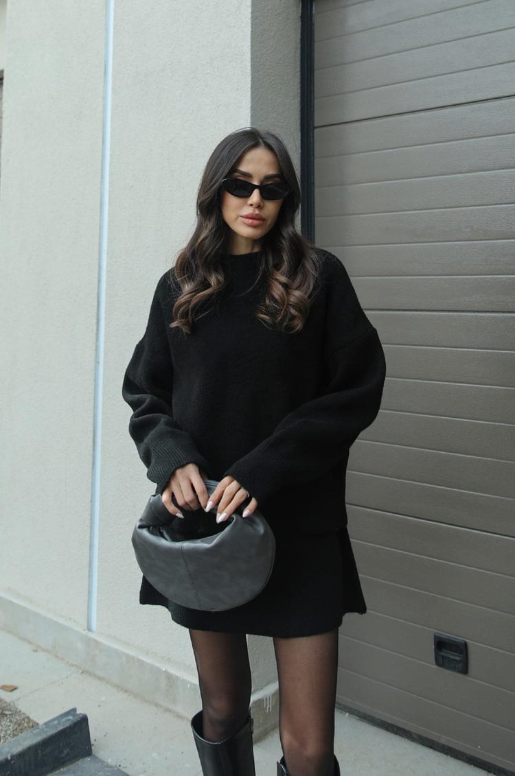 Two-piece women's knitwear set featuring a short sleeve sweater and high-waisted mini skirt