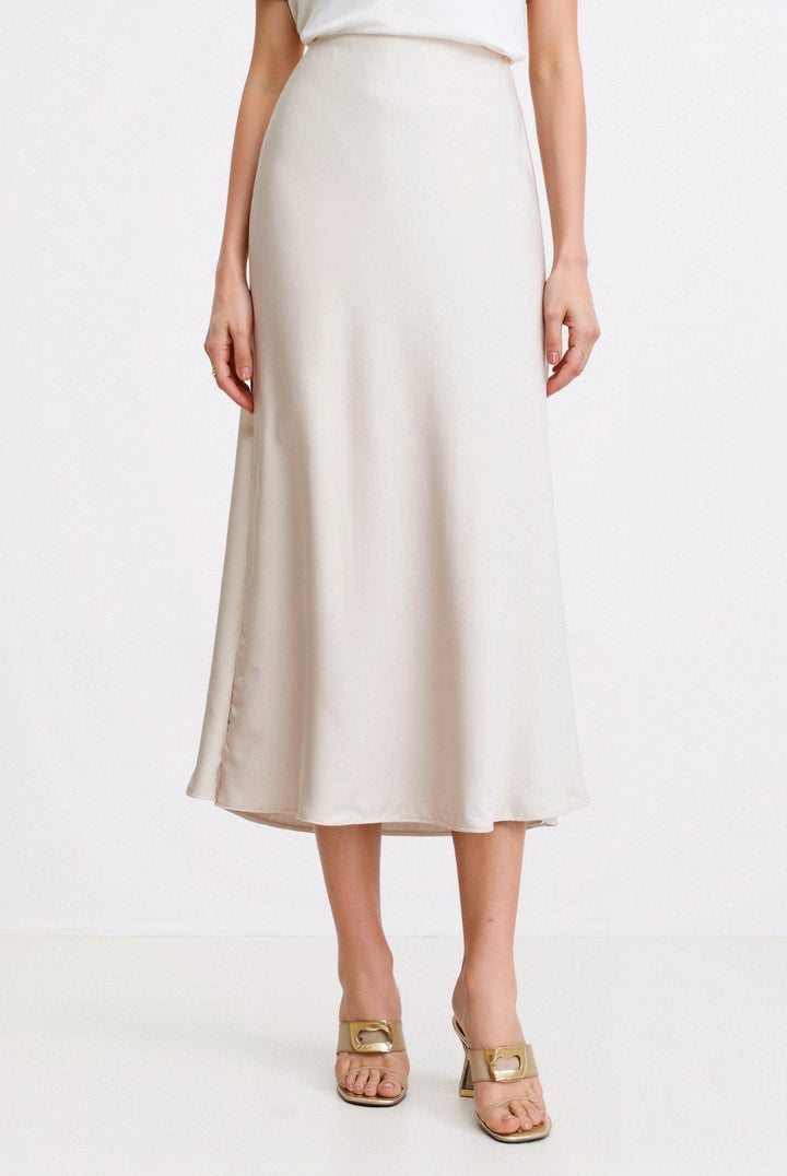 Women's cream white high waist flowing maxi skirt, ideal for elegant summer fashion or casual wear.