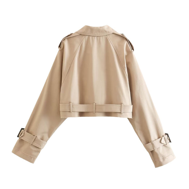 Modern women's short trench coat in a double-breasted style, a fashionable outerwear piece.