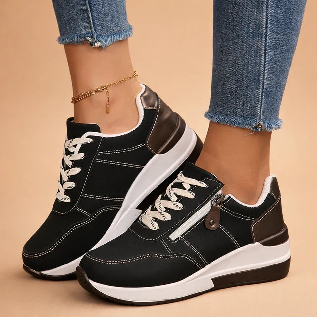 Stylish women's low-top sneakers with perforated design, offering comfort for spring and summer casual wear.