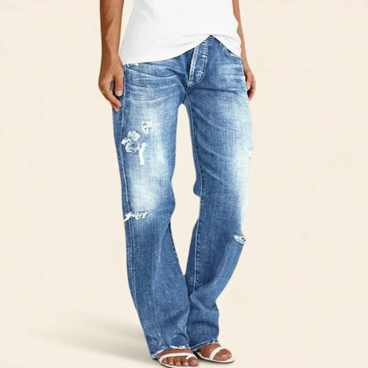 Distressed dark blue women's jeans with a high rise and straight leg, ideal for everyday wear.