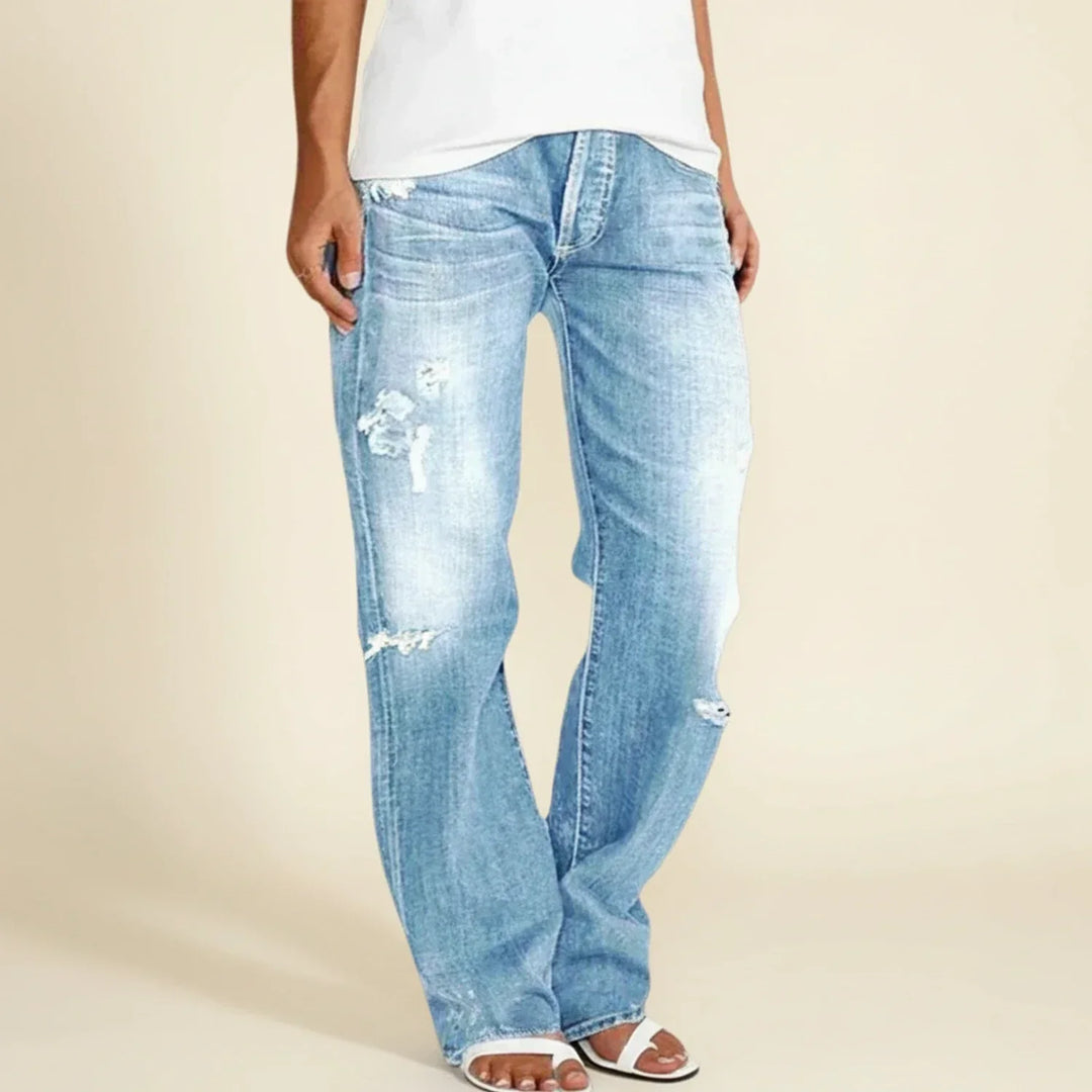 Full-length view of women's dark wash ripped high-rise straight jeans, a trendy casual look.