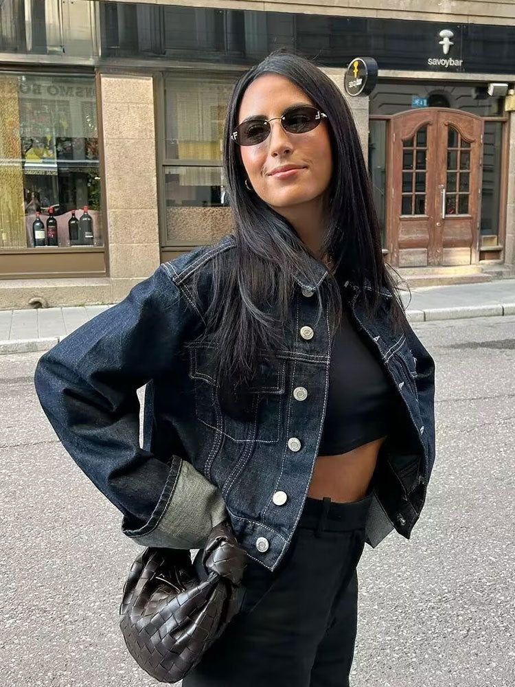 Denim blue cropped jacket with button closure and coordinating casual pants for women's spring fashion.