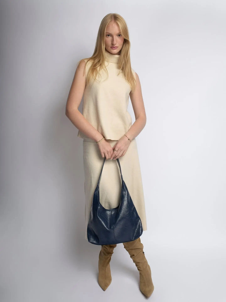 Distressed leather tote with a secure closure, a practical women's handbag